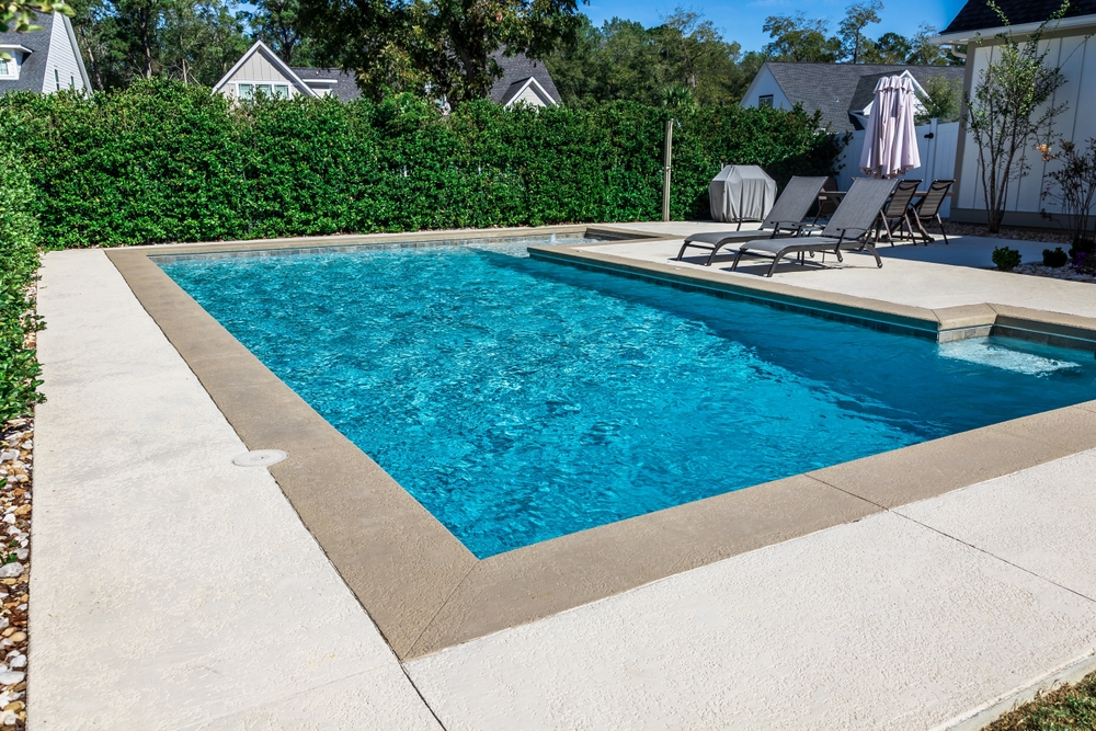 A,rectangular,new,swimming,pool,with,tan,concrete,edges,in